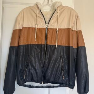 reversible hooded windbreaker jacket with a fleece lining